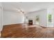 A bright living room with wood floors, a fireplace, and natural light from windows and doors at 4515 Ambassador Way, Cumming, GA 30040