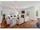 Bright living room with fireplace, white furniture, and wood floors at 4515 Ambassador Way, Cumming, GA 30040