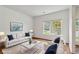 Staged living room with bright white walls and an accent of blue at 4515 Ambassador Way, Cumming, GA 30040