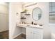 Bathroom vanity with a framed mirror and decorative shelving at 4578 Score Ct, Snellville, GA 30039