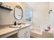 Bathroom with a tub, shower, single sink vanity, and a large framed mirror at 4578 Score Ct, Snellville, GA 30039