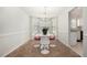 Bright dining area featuring a modern chandelier, table with chairs, and a bay window at 4578 Score Ct, Snellville, GA 30039