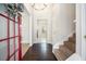Open entryway with dark floors and a red-trimmed glass door welcomes guests at 4578 Score Ct, Snellville, GA 30039