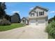 A lovely two-story home has a two-car garage and large driveway with mature trees at 4578 Score Ct, Snellville, GA 30039
