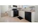 The kitchen features white cabinets, a black oven, and a black dishwasher at 4578 Score Ct, Snellville, GA 30039
