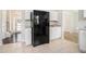 This kitchen has a large black refrigerator and tile flooring at 4578 Score Ct, Snellville, GA 30039