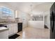 Bright eat-in kitchen with tiled floor, black appliances, and modern lighting at 4578 Score Ct, Snellville, GA 30039