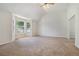 Spacious living room with neutral carpet, vaulted ceilings, and a large bay window at 4578 Score Ct, Snellville, GA 30039