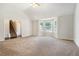 Cozy living room with neutral carpet, vaulted ceiling, and a staircase in view at 4578 Score Ct, Snellville, GA 30039