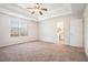 Spacious main bedroom with carpet, trey ceiling, and natural light from a large window at 4578 Score Ct, Snellville, GA 30039
