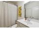 Bathroom featuring a shower with curtain, single sink vanity, and a mirror at 178 Munira Sw Ln, Atlanta, GA 30331