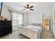 Bright bedroom with a queen bed, ceiling fan, neutral carpet, and a large window at 178 Munira Sw Ln, Atlanta, GA 30331