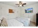 Modern bedroom with a TV, ceiling fan, and a white bed frame at 178 Munira Sw Ln, Atlanta, GA 30331