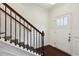 Inviting entryway with hardwood floors, classic wainscoting, and a staircase with dark wood handrail at 178 Munira Sw Ln, Atlanta, GA 30331