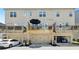 Rear exterior view of townhomes featuring garage and balcony at 178 Munira Sw Ln, Atlanta, GA 30331