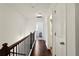 Second floor hallway featuring hardwood floors and white walls at 178 Munira Sw Ln, Atlanta, GA 30331