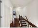 Upstairs hallway with dark wood floors and white trim at 178 Munira Sw Ln, Atlanta, GA 30331
