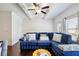 Comfortable living room with a blue sectional sofa, ceiling fan, and ample natural light at 178 Munira Sw Ln, Atlanta, GA 30331