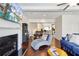 Open-concept living room featuring a fireplace, dining area, and hardwood floors at 178 Munira Sw Ln, Atlanta, GA 30331