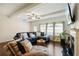 Elegant living room showcasing a blue sectional sofa, plush pillows, and a fireplace at 178 Munira Sw Ln, Atlanta, GA 30331