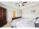Bedroom featuring tray ceiling, neutral carpet, and en-suite bathroom at 178 Munira Sw Ln, Atlanta, GA 30331