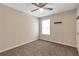 Cozy bedroom with soft carpet flooring, a ceiling fan, and natural light from the window at 2907 Timbercreek Cir, Roswell, GA 30076