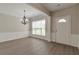 Dining room with elegant chandelier, wainscoting, neutral paint, and modern flooring at 2907 Timbercreek Cir, Roswell, GA 30076