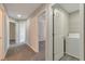 Hallway featuring neutral walls with carpet flooring leading to the laundry room with a washing machine at 2907 Timbercreek Cir, Roswell, GA 30076