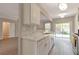 Stylish kitchen with white cabinets, marble countertops, and a view of the living area at 2907 Timbercreek Cir, Roswell, GA 30076