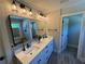 Stylish bathroom featuring double sinks, modern lighting, and a large mirror above the vanity at 3240 Columbia Oaks Way, Decatur, GA 30032