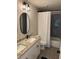 Bathroom featuring double sinks, granite countertop, and patterned tile at 3240 Columbia Oaks Way, Decatur, GA 30032