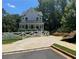 Beautifully designed home with a well-manicured lawn, charming white picket fence, and spacious driveway at 3240 Columbia Oaks Way, Decatur, GA 30032