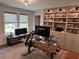 Bright home office with custom built-in shelving, a large desk, and abundant natural light at 3240 Columbia Oaks Way, Decatur, GA 30032