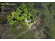 Aerial view of a home on a lush 1.04-acre lot in a wooded area at 6235 Akins Way, Cumming, GA 30041