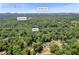 Aerial view of the Cumming, GA home surrounded by lush trees off US Hwy 19 at 6235 Akins Way, Cumming, GA 30041