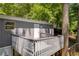 Elevated back deck offering views of a tree-filled backyard at 6235 Akins Way, Cumming, GA 30041