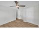 Bedroom with wood-look flooring, ceiling fan, and white doors at 6235 Akins Way, Cumming, GA 30041