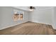 Bright bedroom with wood-look flooring, fan and a window view of the outdoors at 6235 Akins Way, Cumming, GA 30041