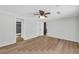 Spacious bedroom with wood-look flooring, ceiling fan, and a door to the bathroom at 6235 Akins Way, Cumming, GA 30041