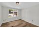 This bedroom features wood-look flooring, a ceiling light, and a large window at 6235 Akins Way, Cumming, GA 30041