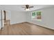 Neutral bedroom with wood-look flooring, ceiling fan, and natural light at 6235 Akins Way, Cumming, GA 30041