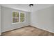 Bright bedroom with new wood flooring and double hung windows with views of the treeline at 6235 Akins Way, Cumming, GA 30041