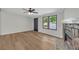 Bright living room with a fireplace, wood-style flooring, and an exterior door at 6235 Akins Way, Cumming, GA 30041