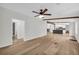Open floorplan showcases wood-look flooring, exposed ceiling beams, and flows into the modern kitchen at 6235 Akins Way, Cumming, GA 30041