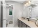 Neutral bathroom with a granite countertop, vanity, and decorative mirror at 630 Buttercup Trce, Johns Creek, GA 30022