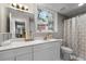 Bathroom featuring white vanity, a modern sink, and a bright window at 630 Buttercup Trce, Johns Creek, GA 30022