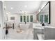 Bright bathroom features a soaking tub, white marble countertops, and tile accents at 630 Buttercup Trce, Johns Creek, GA 30022