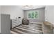 Bedroom with hardwood floors, a large window, and a comfortable chair at 630 Buttercup Trce, Johns Creek, GA 30022