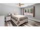 Comfortable bedroom with hardwood floors, neutral walls, and a window overlooking trees at 630 Buttercup Trce, Johns Creek, GA 30022