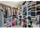 Spacious walk-in closet featuring ample shelving and hanging storage for clothing and accessories at 630 Buttercup Trce, Johns Creek, GA 30022